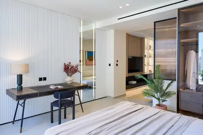 a bedroom with a desk and a bedroom with a bed at Fasma Suites Luxury Apartments in Piraeus in Piraeus