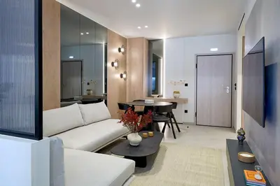 a living room with a white couch and a table at Fasma Suites Luxury Apartments in Piraeus in Piraeus