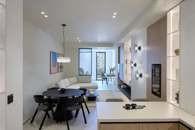 a living room with a table and a couch at Fasma Suites Luxury Apartments in Piraeus in Piraeus