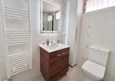 a white bathroom with a sink and a toilet at Krystalli 3BR apartment in Voula by ΜΡS in Athens