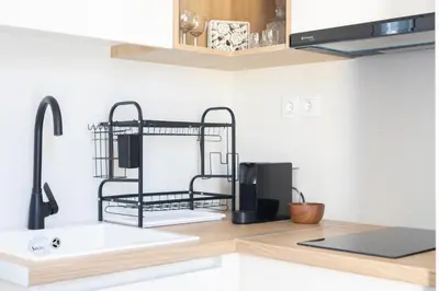 a kitchen counter with a sink and a microwave at Whispering Veranda in Athens
