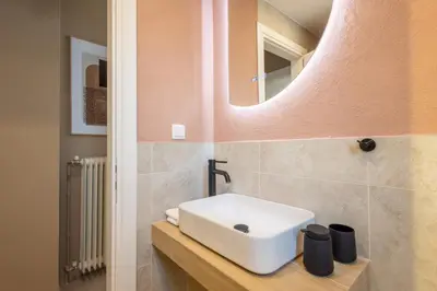 a bathroom with a sink and a mirror at Whispering Veranda in Athens