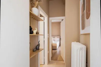 a hallway with a white radiator and a bedroom at Whispering Veranda in Athens