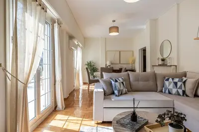 a living room with a couch and a table at Eleni's Terrace in Ampelokipi in Athens