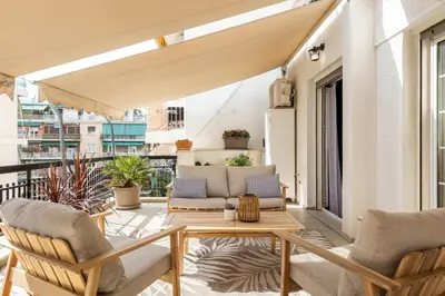 a patio with chairs and a table on a balcony at Eleni's Terrace in Ampelokipi in Athens