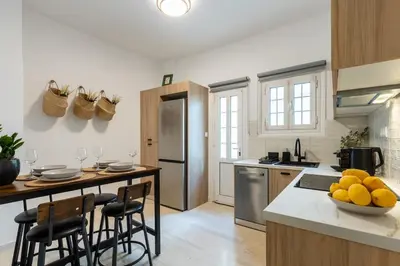 a kitchen with a island with a table and chairs at Eleni's Terrace in Ampelokipi in Athens