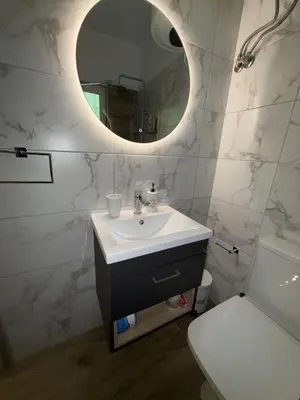 a bathroom with a sink and a mirror at SeaWave Porto Rafti in Porto Rafti