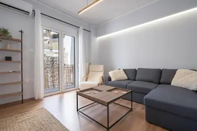 a living room with a couch and a table at Minimal Frame by ΜΡS in Athens