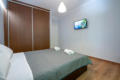 a bedroom with a bed with two towels on it at Minimal Frame by ΜΡS in Athens