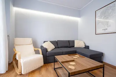 a living room with a couch and a chair at Minimal Frame by ΜΡS in Athens