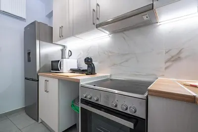 a kitchen with a stove and a refrigerator at Minimal Frame by ΜΡS in Athens