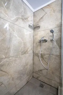 a shower with a shower head in a bathroom at Minimal Frame by ΜΡS in Athens