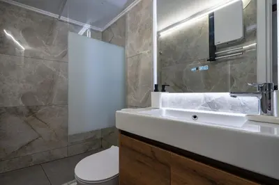 a bathroom with a sink and a toilet and a mirror at Minimal Frame by ΜΡS in Athens