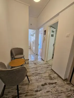 a hallway with chairs and a table in a room at Athens City Center Apartments in Athens