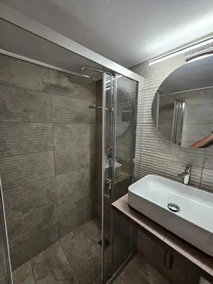 a bathroom with a sink and a glass shower at Athens City Center Apartments in Athens