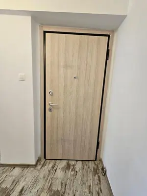 a wooden door in the corner of a room at Athens City Center Apartments in Athens