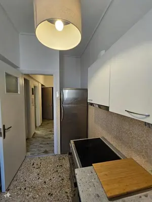 a kitchen with a stainless steel refrigerator and a light at Athens City Center Apartments in Athens