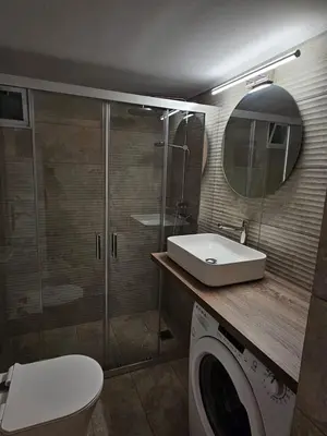 a bathroom with a sink and a washing machine at Athens City Center Apartments in Athens
