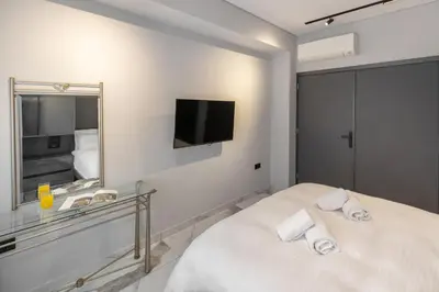 a bedroom with a bed with a mirror and a tv at Syntagma Acropolis M4 in Athens