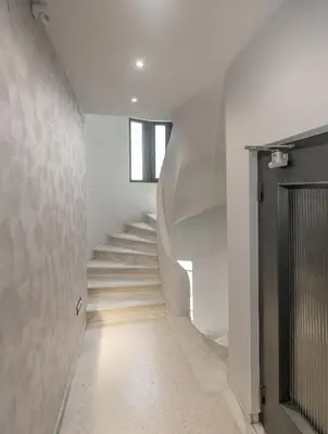 a hallway with white stairs and a window at Syntagma Acropolis M4 in Athens
