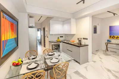 a kitchen with a glass table and chairs at Syntagma Acropolis M4 in Athens