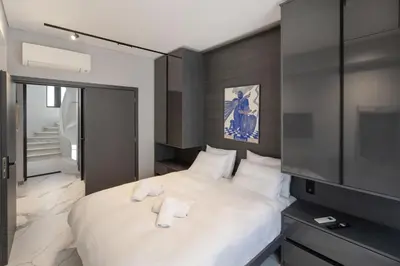 a bedroom with a bed with two towels on it at Syntagma Acropolis M4 in Athens
