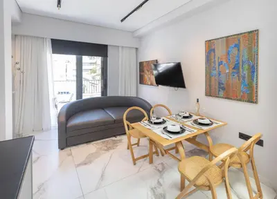 a living room with a table and a couch at Syntagma Acropolis M5 in Athens