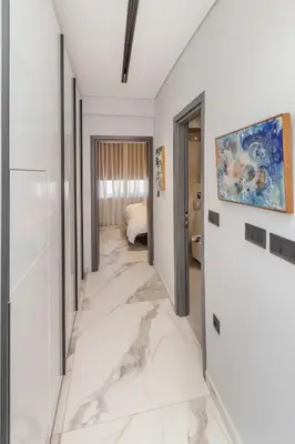 a hallway with white marble flooring in a hotel room at Syntagma Acropolis M5 in Athens