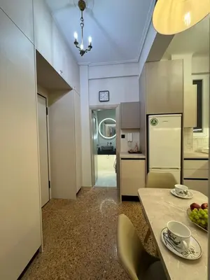 a kitchen with a table with a bowl of fruit on it at Cozy vintage flat in Athens