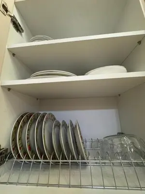 a shelf in a refrigerator with plates and bowls at Cozy vintage flat in Athens