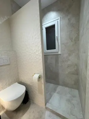 a bathroom with a toilet and a window at Cozy vintage flat in Athens