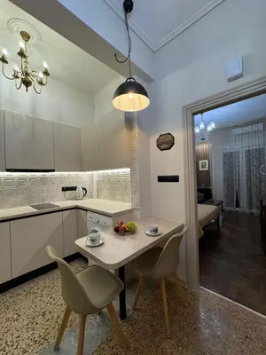 a kitchen with a table and chairs and a dining room at Cozy vintage flat in Athens