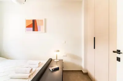 a bedroom with a bed and a table with towels at A43 Renovated in 2025 Great base for Koukaki in Athens
