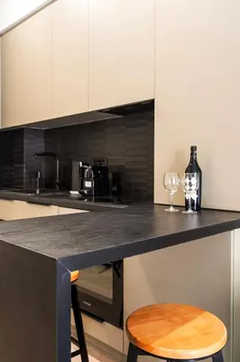 a kitchen with a counter with two wine glasses at A43 Renovated in 2025 Great base for Koukaki in Athens