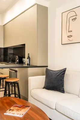 a living room with a white couch and a table at A43 Renovated in 2025 Great base for Koukaki in Athens