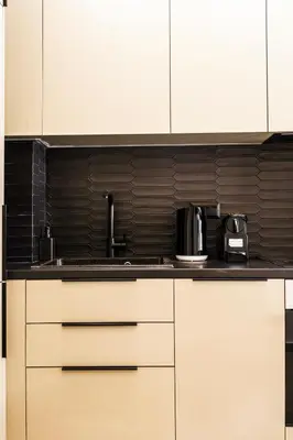 a kitchen with white cabinets and a sink at A43 Renovated in 2025 Great base for Koukaki in Athens