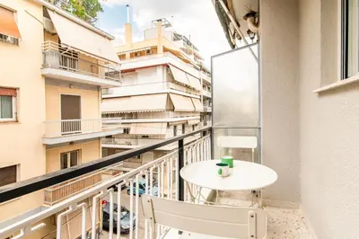 a balcony with a table and chairs on a building at A43 Renovated in 2025 Great base for Koukaki in Athens