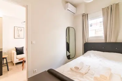 a small bedroom with a bed and a mirror at A43 Renovated in 2025 Great base for Koukaki in Athens