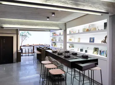 a restaurant with a bar with stools in a room at InnAthens in Athens