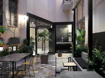 a restaurant with tables and chairs and plants at InnAthens in Athens