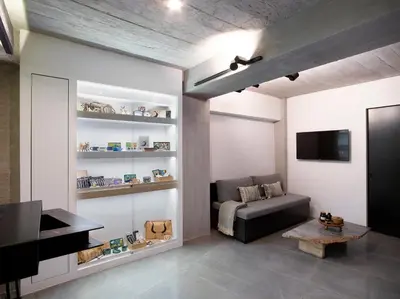 a living room with a couch and a tv at InnAthens in Athens