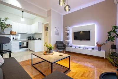 a living room with a table and a kitchen at Beba's House by ΜΡS in Athens