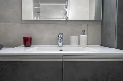 a white sink in a bathroom with a mirror at Beba's House by ΜΡS in Athens