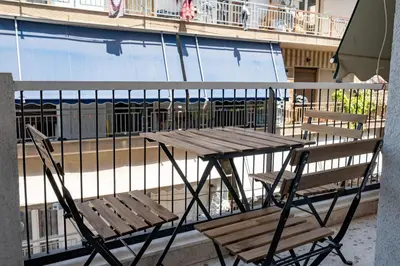 a wooden table and chair sitting on a balcony at Beba's House by ΜΡS in Athens