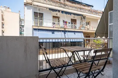 a table and two chairs sitting on a balcony at Beba's House by ΜΡS in Athens