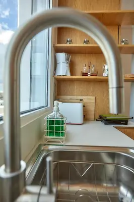 a kitchen counter with a sink and a window at Luxury Penthouse 360 Acropolis and Athens Views in Athens
