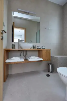 a bathroom with a sink and a mirror at Luxury Penthouse 360 Acropolis and Athens Views in Athens