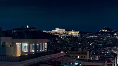 a view of a city at night at Luxury Penthouse 360 Acropolis and Athens Views in Athens