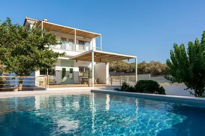 a house with a swimming pool in front of a house at AK-Green Villa near Athens Airport in Vravrona