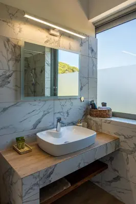 a bathroom with a sink and a mirror at AK-Green Villa near Athens Airport in Vravrona
